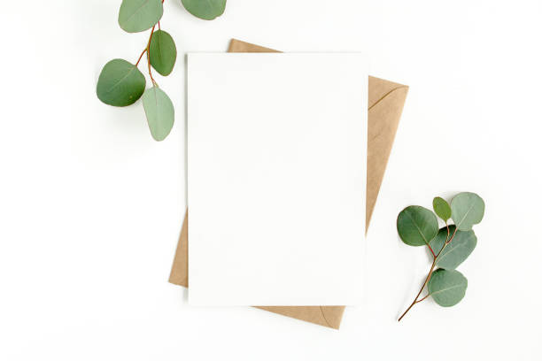istock Mockup invitation, blank greeting card and green leaves eucalyptus. Flat lay, top view 1297741412
