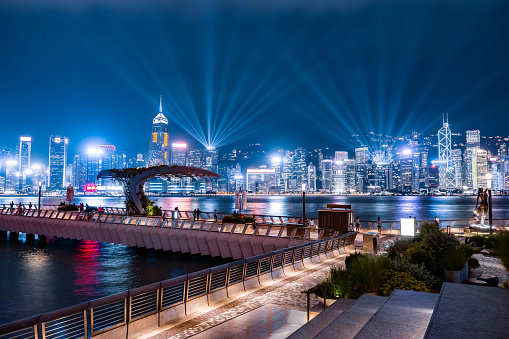Laser light show neon night skyscrapers glittering Hong Kong harbour