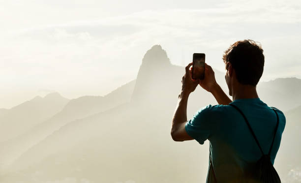 istock Traveler taking photos with his cell phone 1297742482