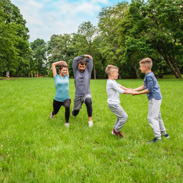 istock Family doing stretching exercises in nature. 1297744697