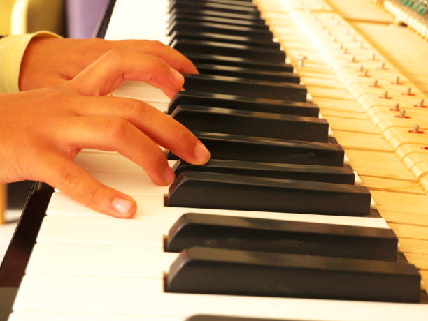istock Close-up of a child's hands playing a piano. 1297744860