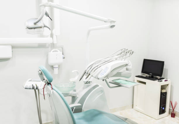 istock White dental chair with computer in medical office. Modern design 1297746162