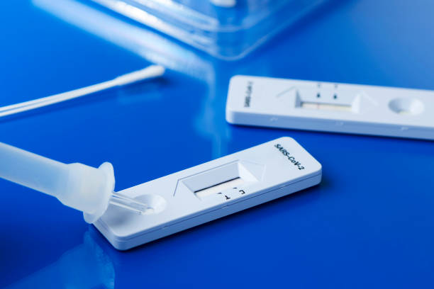 covid-19 rapid antigen test kits some covid-19 rapid antigen test kits, with the diagnostic test devices and some nasopharyngeal swabs, on a blue surface antigen stock pictures, royalty-free photos & images