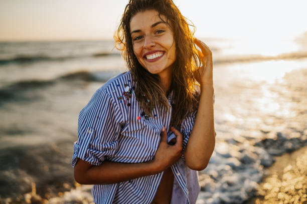 istock Beautiful young woman at the beach 1297748940