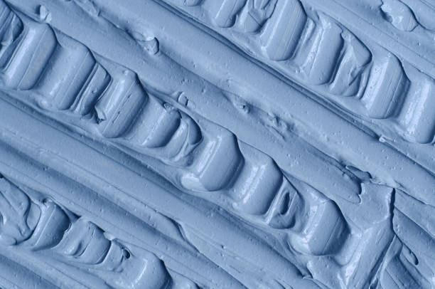 istock Light blue facial clay (mask, face cream, body wrap) texture close up, selective focus. Abstract background with brush strokes. 1297750691