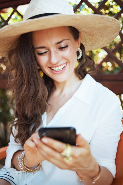istock happy 40 years old woman in shirt using smartphone app 1297751021