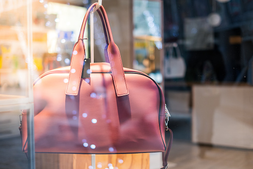 woman bag on store showcase window with bokeh light and no people background .