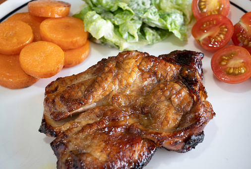 Air fried Teriyaki Chicken Chop served with carrots, salad and tomatoes.