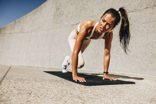 istock Healthy woman doing mountain climbers exercise 1297751820