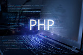 PHP inscription against laptop and code background. Learn php programming language, computer courses, training.