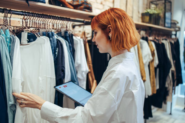 istock Woman taking inventory in clothing store 1297753502