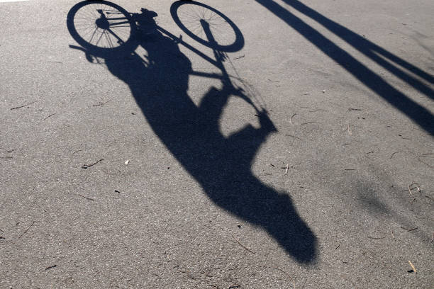 istock the shadow of a riding cyclist on a sunny day 1297755359