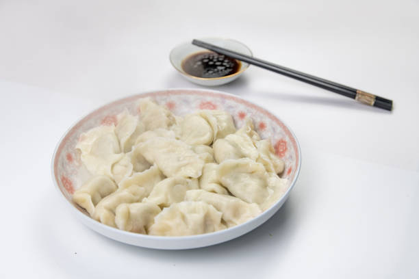 Dumplings and vinegar on a white background