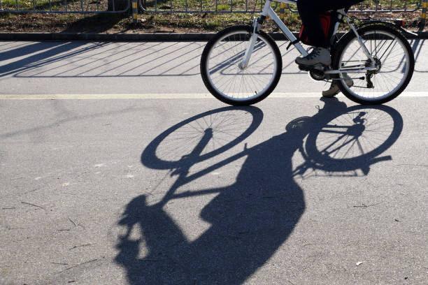 istock the shadow of a riding cyclist on a sunny day 1297755384
