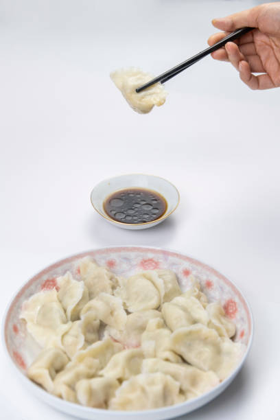 istock Dumplings and vinegar on a white background 1297756014