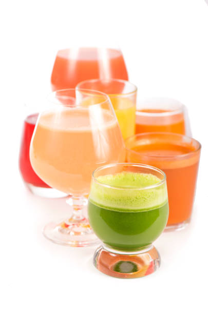 istock Glasses with fresh organic vegetable and fruit juices isolated on white 1297756433