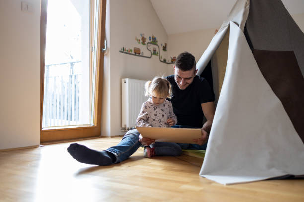 istock Happy father having fun in kid's room 1297757641
