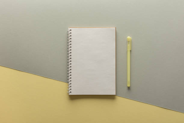 istock Open spiral notepad on gray and yellow background 1297758744