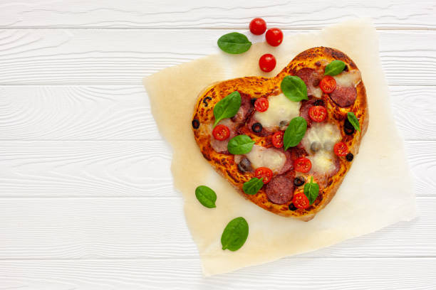 istock Heart shaped pizza for valentine's day 1297760086