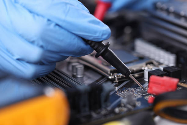 istock Gloved technician with tester checks motherboard closeup 1297762145