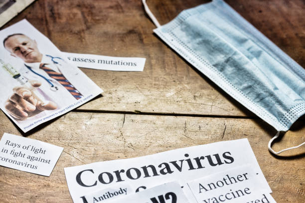 istock Newspaper headlines about COVID-19 pandemic 1297762482