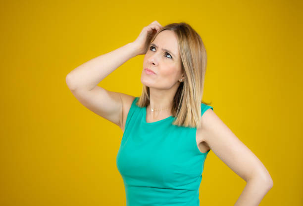 istock Young pretty woman looking sideways with doubtful and skeptical expression. 1297762700