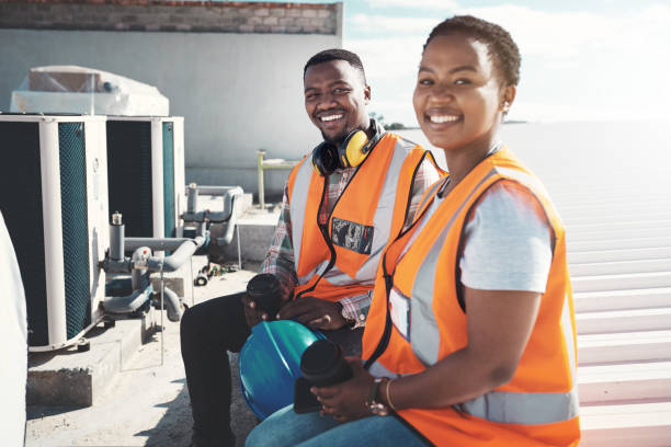 A quick coffee break then we're back in action Shot of a young man and woman having a coffee break at a construction site construction lunch break stock pictures, royalty-free photos & images