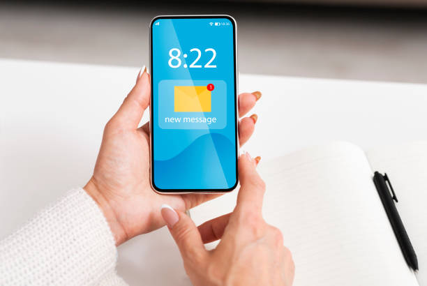 istock Newsletter Concept. Woman Using Smartphone With New Mail Notification Icon On Screen 1297763442