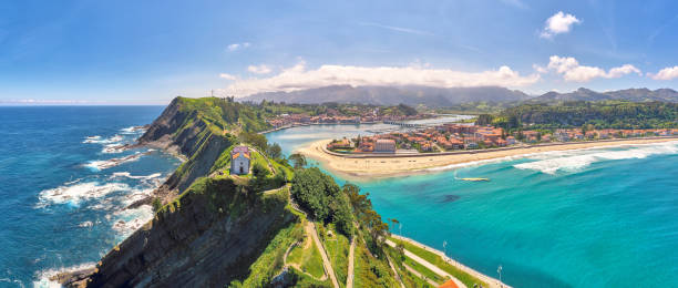 Aerial panorama of a church on top of the cliff in Ribadesella, Asturias Aerial panorama of a church on top of the cliffs, views of the beach and mountains on the background asturias photos stock pictures, royalty-free photos & images