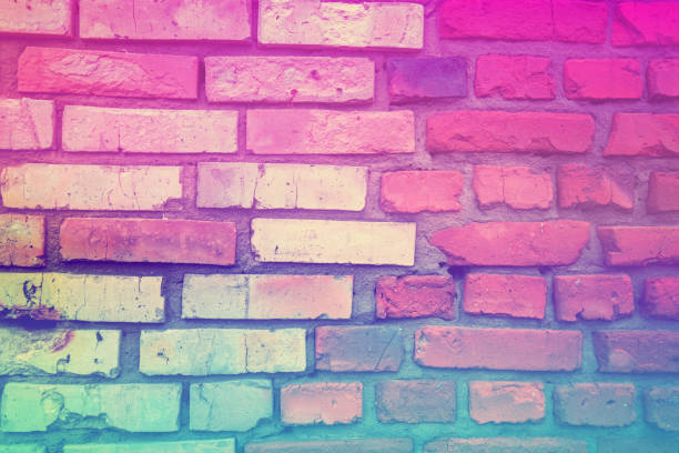 istock Brick wall background. Handmade clay brick. Hot pink green gradient color 1297763994