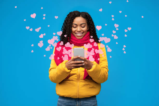 istock Black Woman Texting On Phone Sending Hearts On Blue Background 1297764359