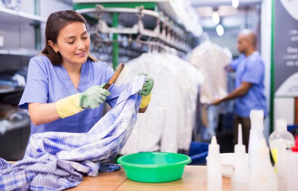 istock Experienced woman working in dry cleaner 1297765229