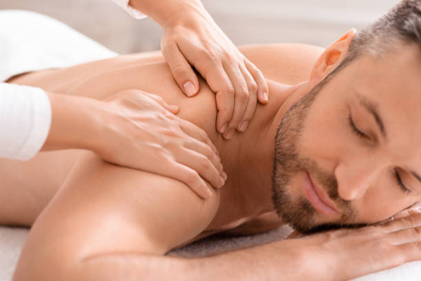istock Closeup of bearded man having relaxed body massage 1297765403