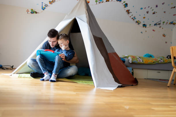 istock Playfull father having fun in kid's room 1297765743