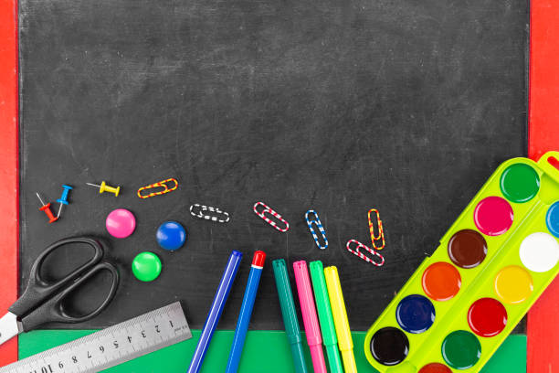 istock school supplies are scattered on a dark background. 1297765930