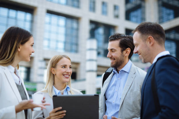 istock Group of managers collaborating on project using digital tablet outdoors 1297766267