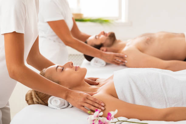 istock Spouses Receiving Shoulders Massage Relaxing At Luxury Spa Center 1297766464