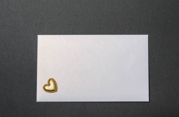 istock white envelope and golden hearts on a black top 1297766480