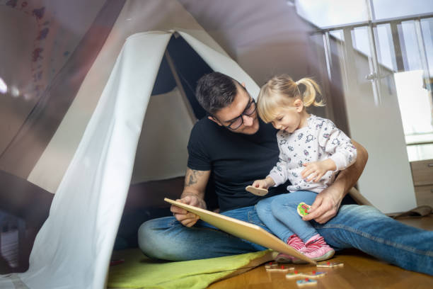 istock Happy father having fun in kid's room 1297767139