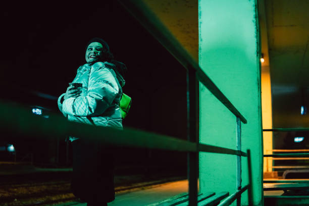 istock Young woman waiting on train station 1297767588
