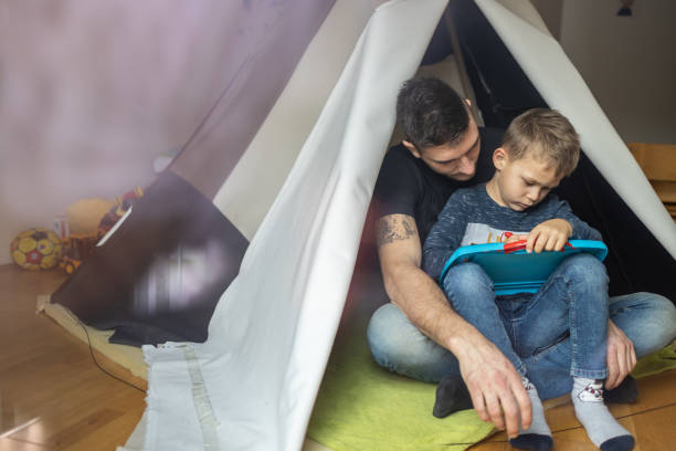 istock Playfull father having fun in kid's room 1297768691
