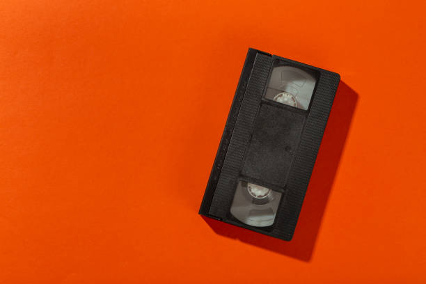 Videotape without a cover on an orange background.