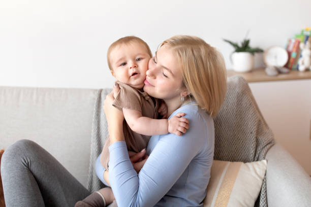 istock Affectionate young mother cuddling with her little baby 1297768839