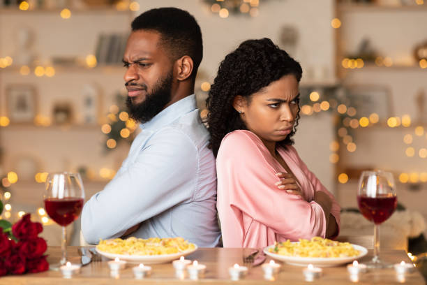 istock Unhappy Black Couple Sitting Back To Back On Date 1297770064