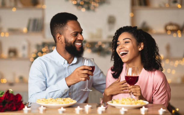 happy black woman and man drinking wine and laughing - foods and drinks clothing garment household equipment imagens e fotografias de stock