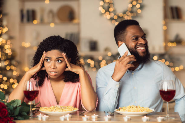 istock Angry Black Woman On Date, Man Talking On Phone 1297770257