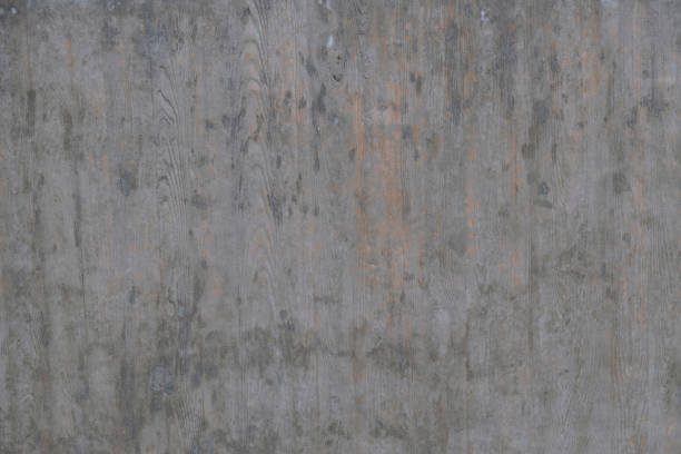 istock Textured background of an old wall made of beige plaster. Smooth surface. Copy space. Old peeling plaster wall, crumbles. Concrete is made under the gray wood texture. 1297770363