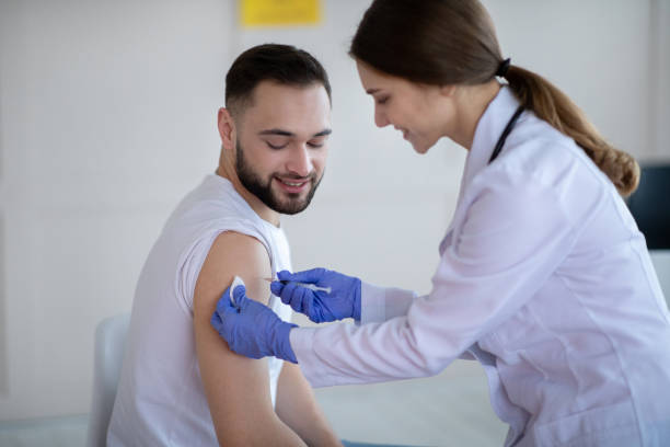 istock General practitioner vaccinating young male patient, making covid-19 vaccine injection at clinic 1297770364