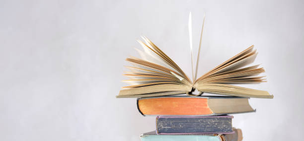 istock opened book and stack of book,reading,education,home office, back to school concept, selective focus,free copy space 1297770436