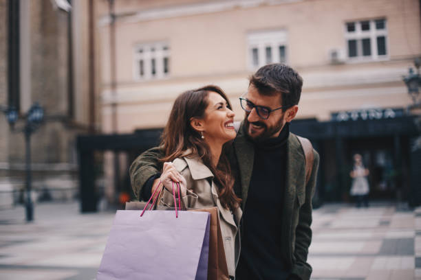 young smiling couple enjoys in promenade. - pair couple mid adult happiness imagens e fotografias de stock